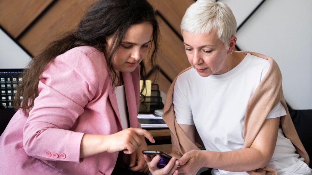 Two people looking a smartphone